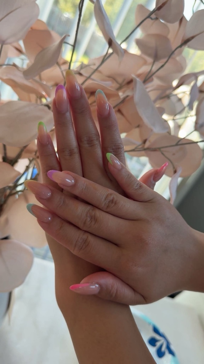 Almond nails with sheer pastel rainbow French tips at Lumi Studio